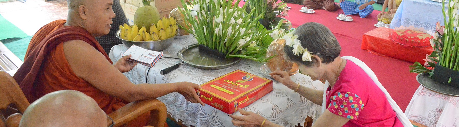 A Monestary Devotee offering donation dana robes to Sayadaw U Jotika.
